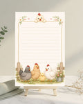 Notepad with cartoon chickens on a stand next to a vase and fabric on a light surface.